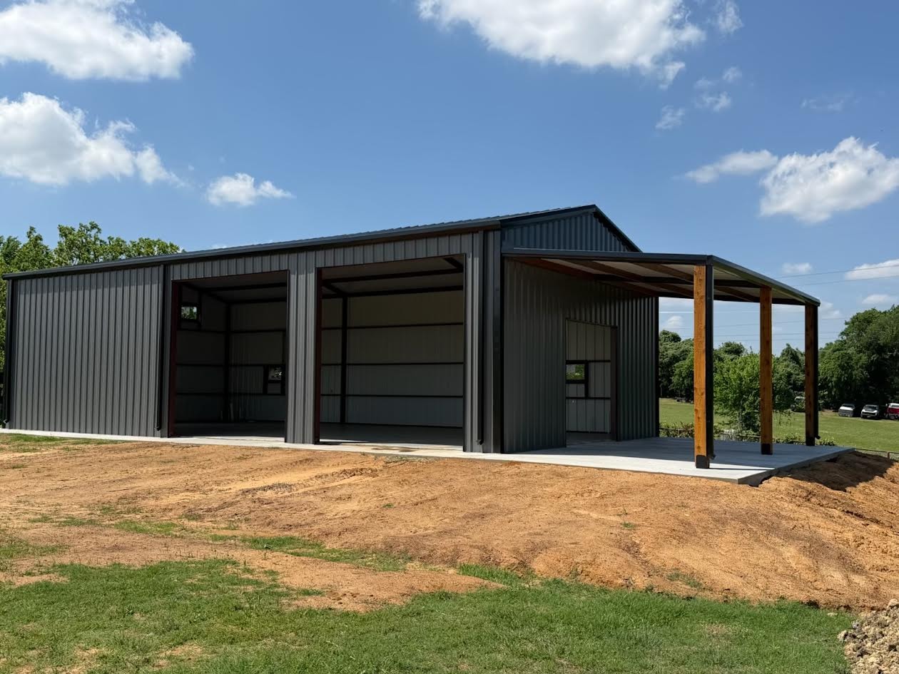 Dark gray metal commercial building with lean-to porch