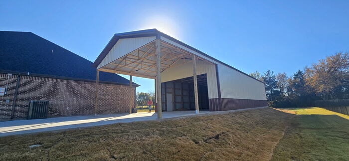 Post frame building with lean-to carport attached