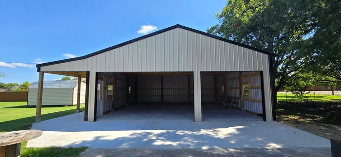 Open-front post frame garage with three bays