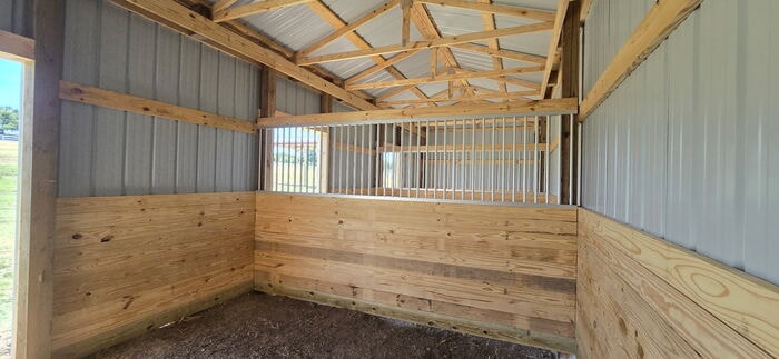Interior horse stall in post frame barn